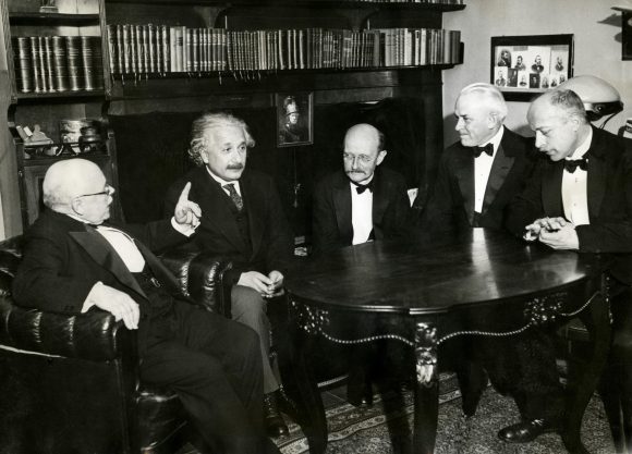 From left to right: W. Nernst, A. Einstein, M. Planck, R.A. Millikan and von Laue at a dinner given by von Laue in 1931. Credit: Wikipedia Commons